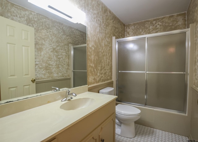 2115 Heather Ln, Tyler, TX 75703 - full bathroom with wallpapered walls, toilet, vanity, shower / bath combination with glass door, and tile patterned flooring