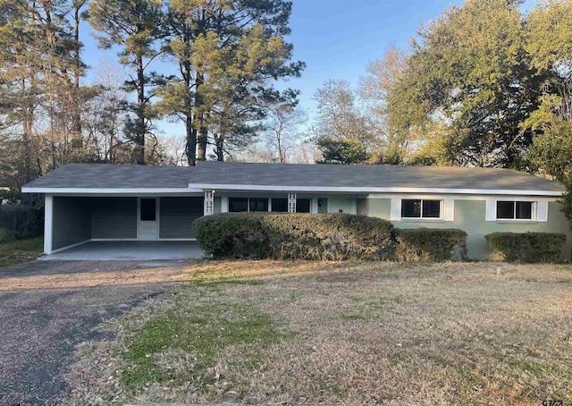 ranch-style house featuring a carport