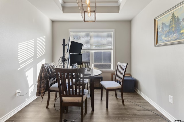 dining area featuring ornamental molding and dark wood-type flooring