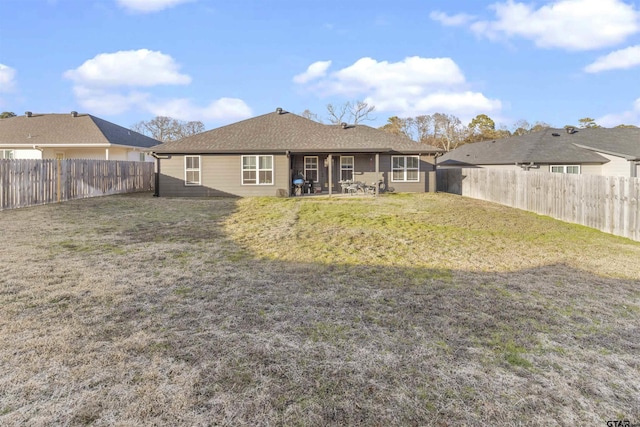 back of property featuring a yard and a patio