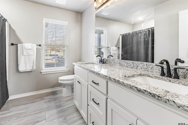 bathroom with vanity, toilet, and walk in shower