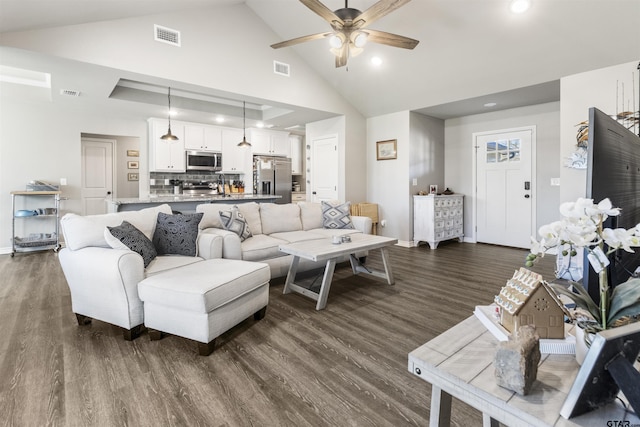 living room featuring dark hardwood / wood-style floors, ceiling fan, and lofted ceiling