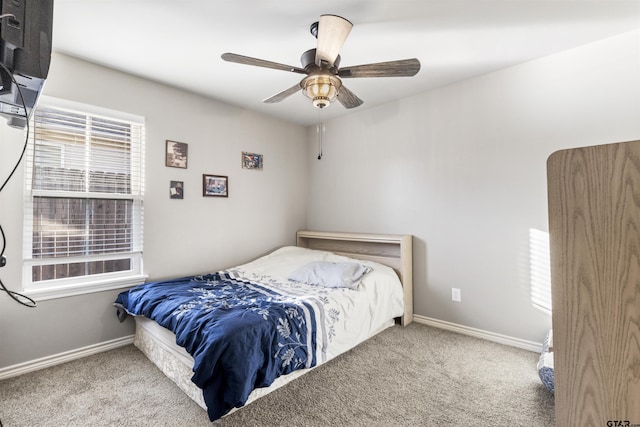 carpeted bedroom with multiple windows and ceiling fan