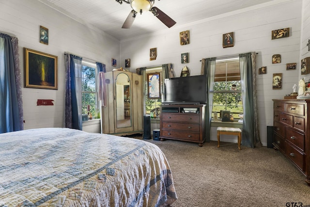 carpeted bedroom with multiple windows, ceiling fan, and crown molding