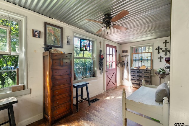 interior space featuring wood-type flooring, plenty of natural light, and ceiling fan