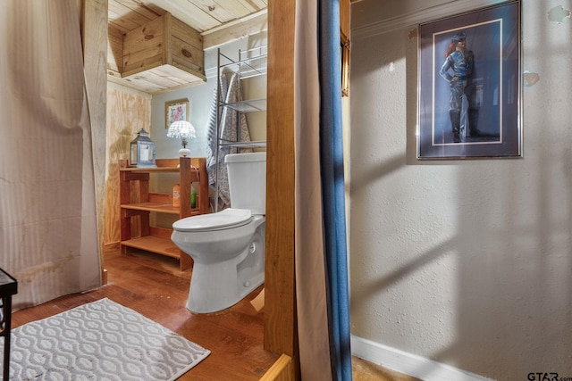 bathroom with hardwood / wood-style floors, toilet, and wooden ceiling