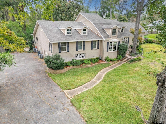 cape cod home with a front yard and cooling unit