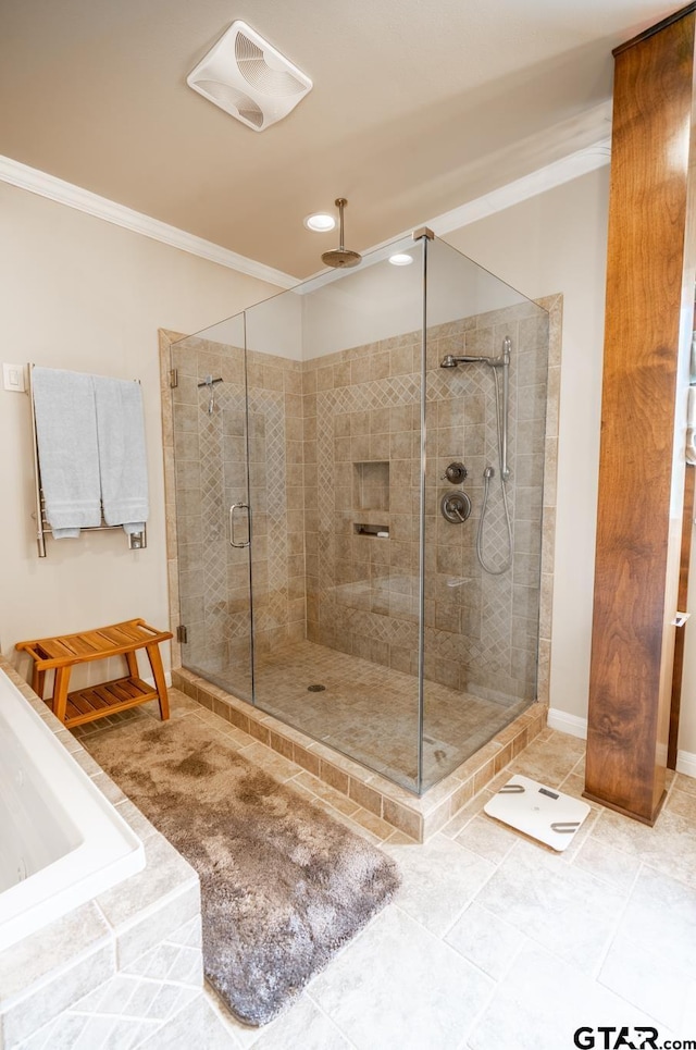 bathroom with a shower with door, ornamental molding, and tile patterned floors