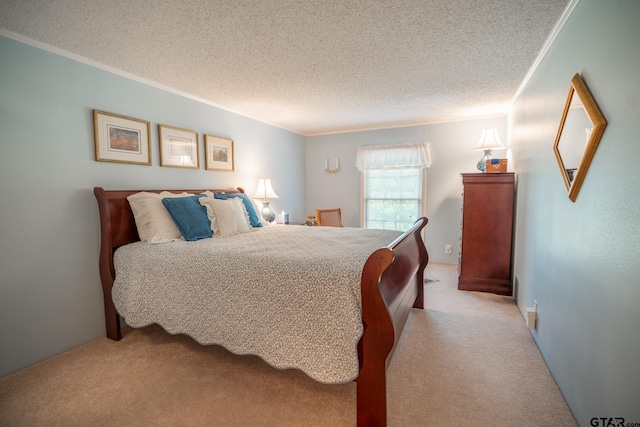 bedroom with ornamental molding, light colored carpet, and a textured ceiling