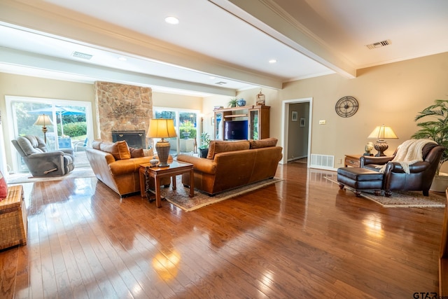 living room featuring beamed ceiling, hardwood / wood-style floors, and a fireplace