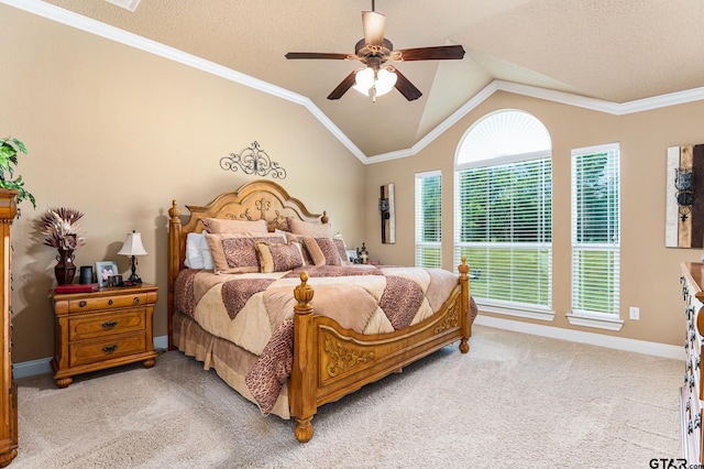 carpeted bedroom with a textured ceiling, lofted ceiling, ceiling fan, and crown molding