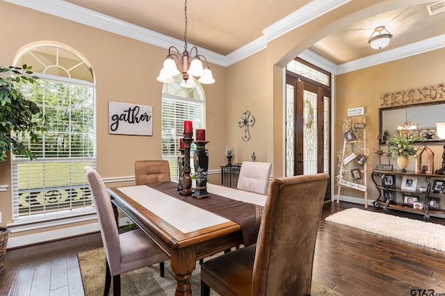 dining area featuring a wealth of natural light, dark wood-type flooring, and a chandelier