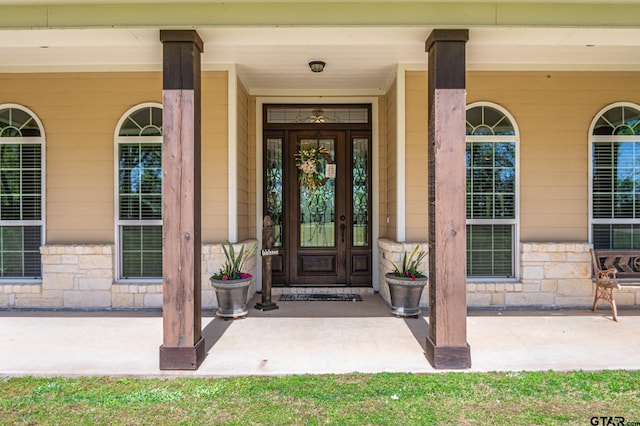 doorway to property with a porch