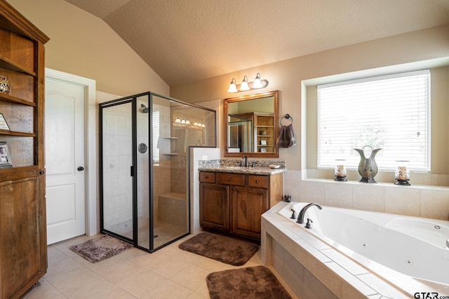 bathroom featuring a textured ceiling, vanity, plus walk in shower, lofted ceiling, and tile patterned floors