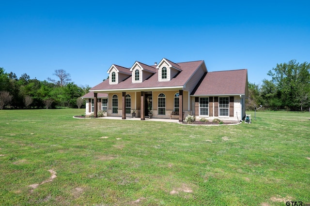 cape cod house featuring a porch and a front lawn