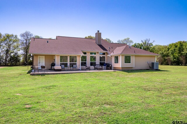 909 Crk 3045, Crockett, TX 75835 - back of house featuring a chimney, a patio area, a lawn, and central air condition unit
