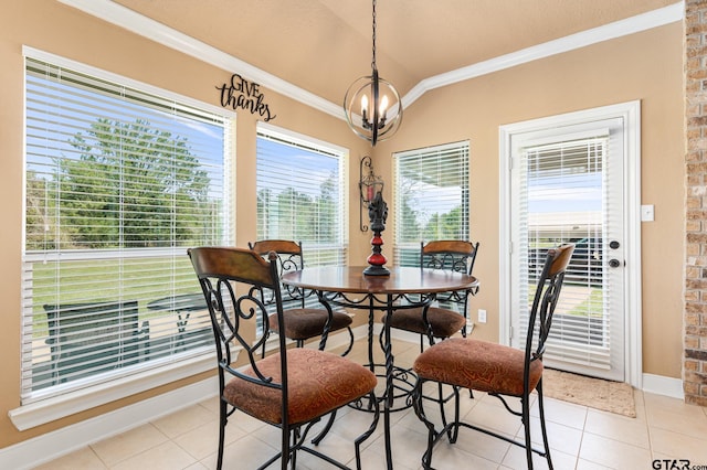 tiled dining space featuring ornamental molding and an inviting chandelier