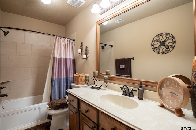 full bathroom with toilet, shower / bath combo, vanity, and a textured ceiling