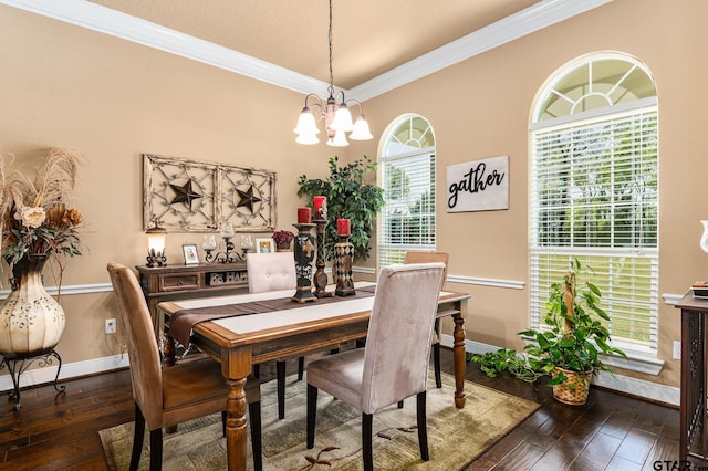 dining space with dark wood-type flooring, a chandelier, and crown molding