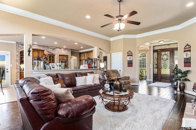 909 Crk 3045, Crockett, TX 75835 - living room with arched walkways, plenty of natural light, dark wood-style flooring, ornamental molding, and recessed lighting