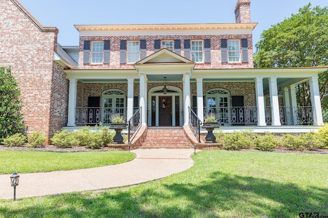 view of front facade with a front lawn and a porch