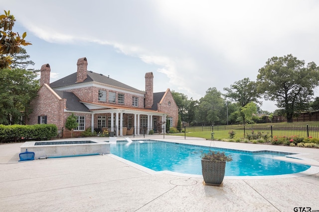 view of swimming pool featuring an in ground hot tub and a patio