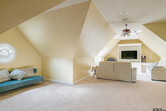 living room featuring carpet flooring, ceiling fan, and lofted ceiling