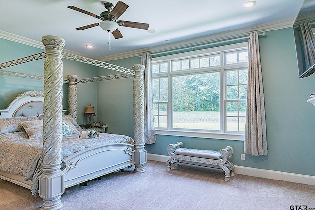 carpeted bedroom featuring ceiling fan and ornamental molding