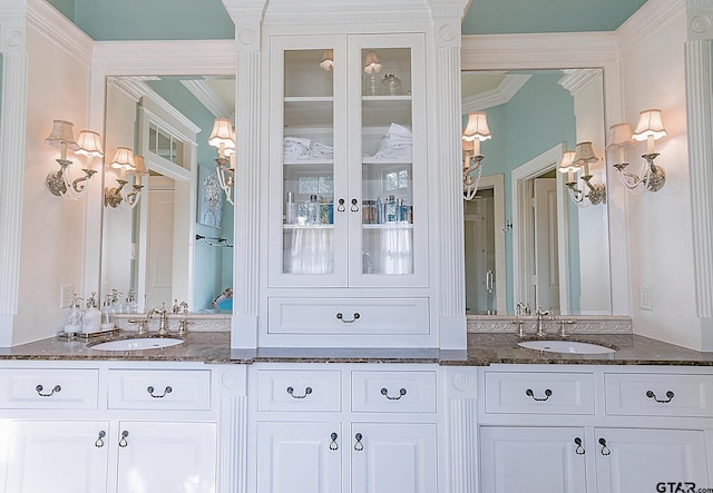 bathroom with vanity and ornamental molding