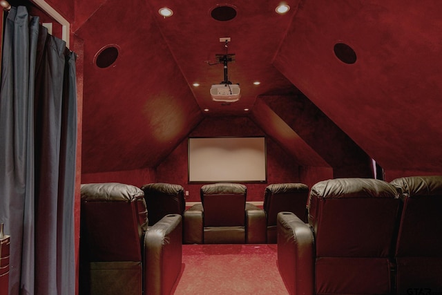 home theater featuring light colored carpet and vaulted ceiling