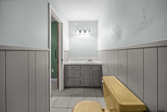 bathroom featuring vanity, a textured ceiling, and tile patterned flooring