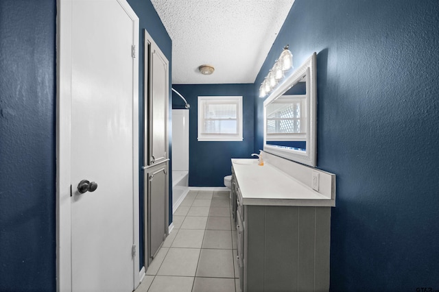 full bathroom with tile patterned floors, toilet, a textured ceiling, vanity, and bathtub / shower combination