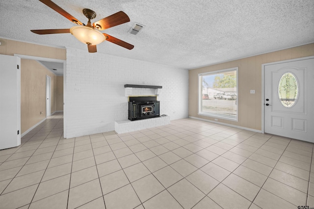 unfurnished living room featuring ceiling fan, a textured ceiling, and light tile patterned floors