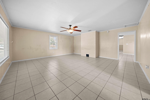 tiled spare room featuring ceiling fan and ornamental molding