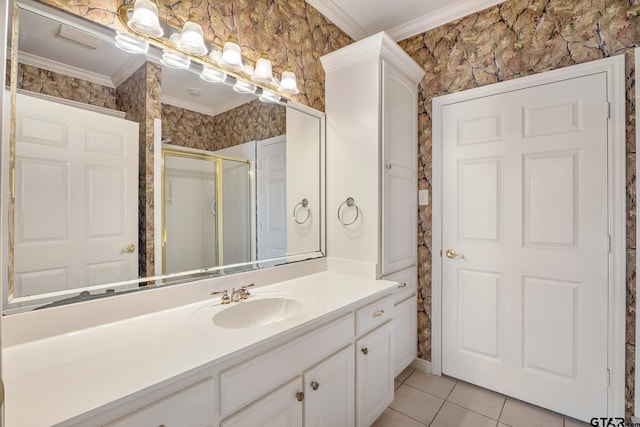 bathroom with vanity, tile patterned flooring, an enclosed shower, and crown molding