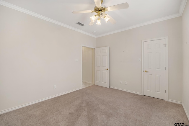 carpeted empty room with ornamental molding and ceiling fan