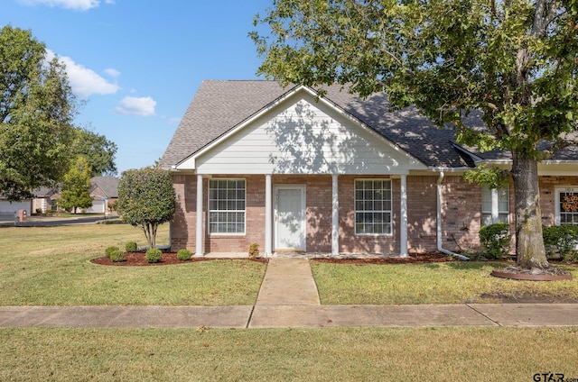 bungalow-style home with a front yard