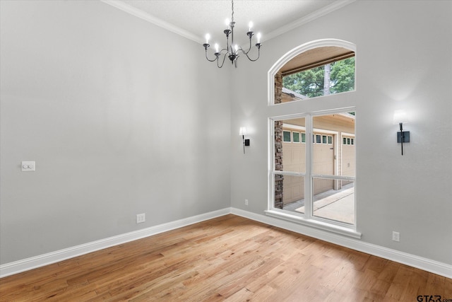 89 Eagle Cv, Mount Vernon, TX 75457 - spare room with a chandelier, light wood-style floors, ornamental molding, and baseboards