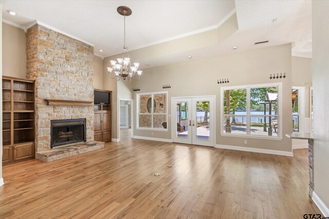 unfurnished living room featuring light hardwood / wood-style floors and crown molding