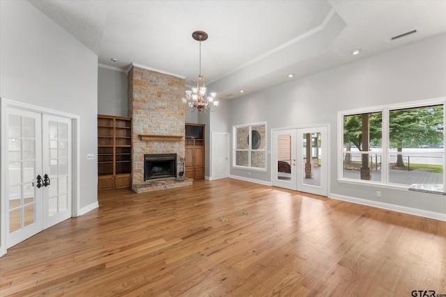 89 Eagle Cv, Mount Vernon, TX 75457 - unfurnished living room with french doors, ornamental molding, recessed lighting, light wood-style flooring, and built in shelves