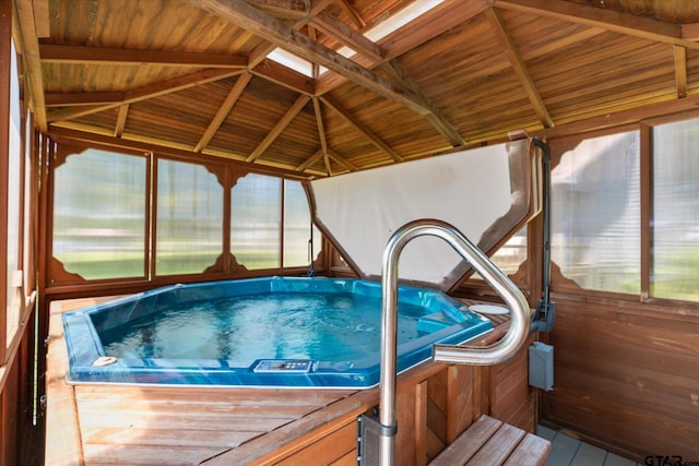 view of swimming pool with an indoor hot tub