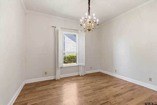 spare room featuring hardwood / wood-style floors and crown molding