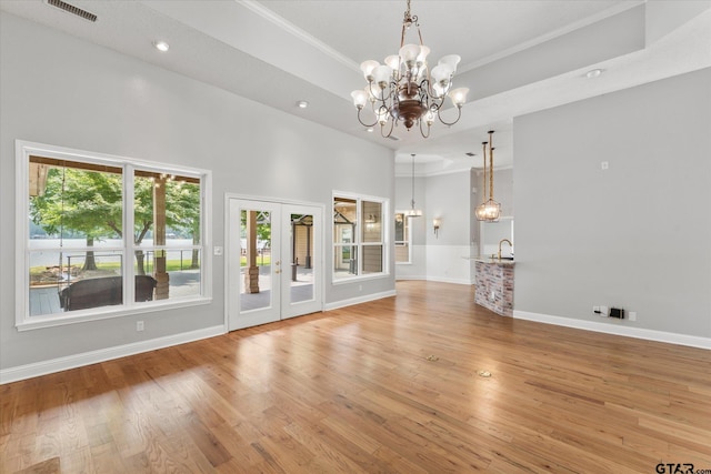 89 Eagle Cv, Mount Vernon, TX 75457 - unfurnished living room with a chandelier, light wood finished floors, crown molding, baseboards, and recessed lighting