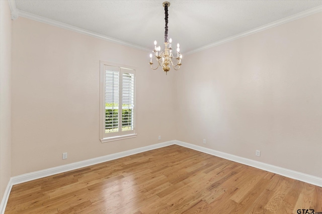 89 Eagle Cv, Mount Vernon, TX 75457 - spare room with a chandelier, light wood finished floors, crown molding, and baseboards