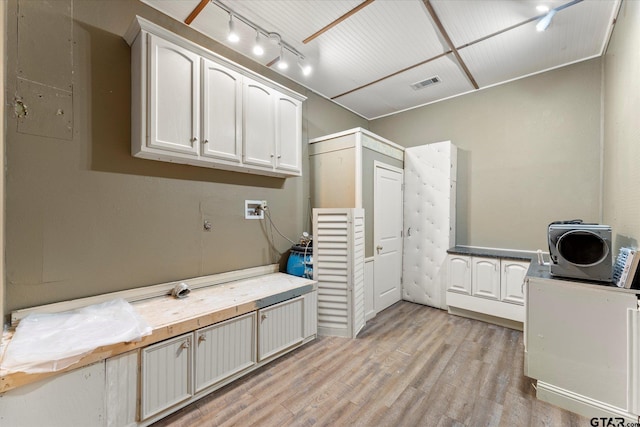 89 Eagle Cv, Mount Vernon, TX 75457 - laundry room with cabinet space, light wood-style flooring, rail lighting, and washer hookup