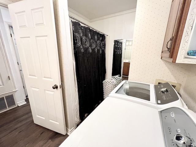 laundry area with dark wood-type flooring, crown molding, and cabinets