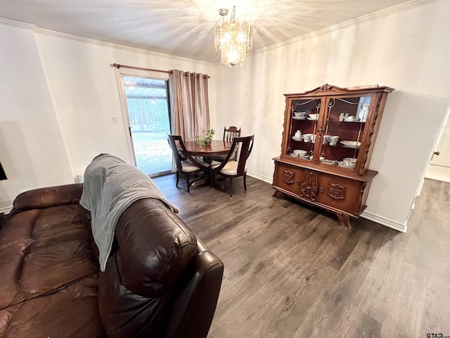 living room with dark hardwood / wood-style floors, crown molding, and a chandelier