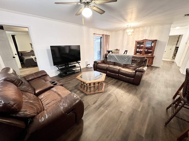 living room with ornamental molding, ceiling fan with notable chandelier, and dark hardwood / wood-style flooring