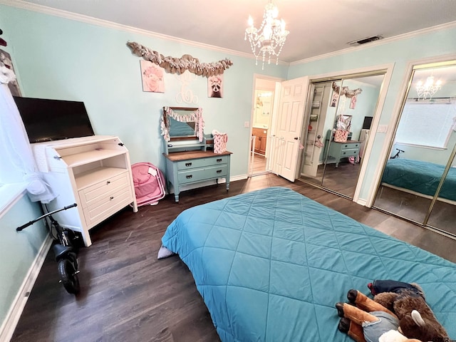 bedroom featuring a closet, dark wood-type flooring, ornamental molding, and a notable chandelier