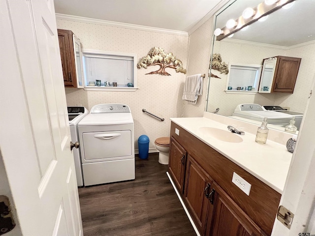 bathroom featuring toilet, separate washer and dryer, crown molding, and hardwood / wood-style floors